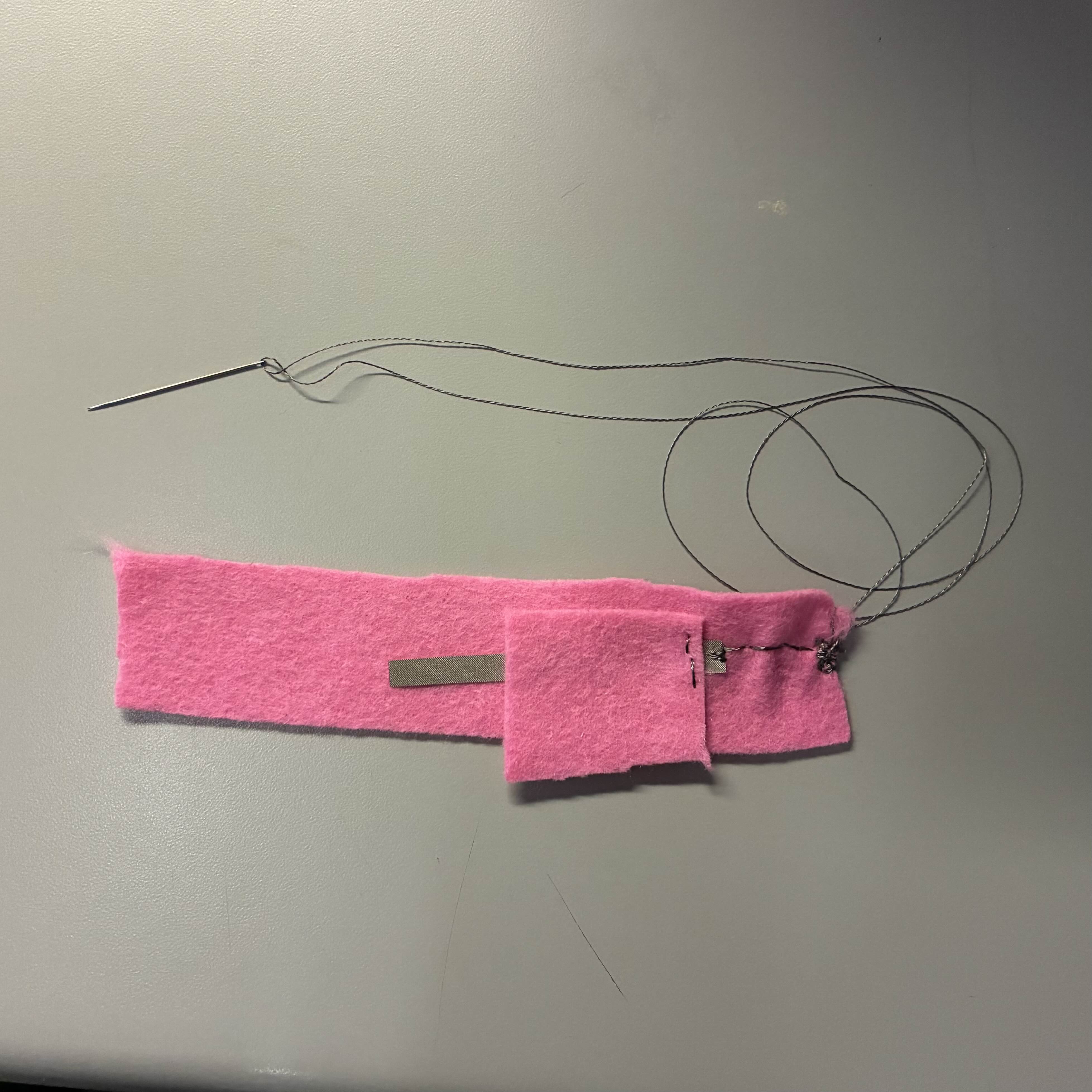 This was my process trying to make a long battery holder with conductive thread and fabric. My goal was to make both the ends touch and have the light would turn on.