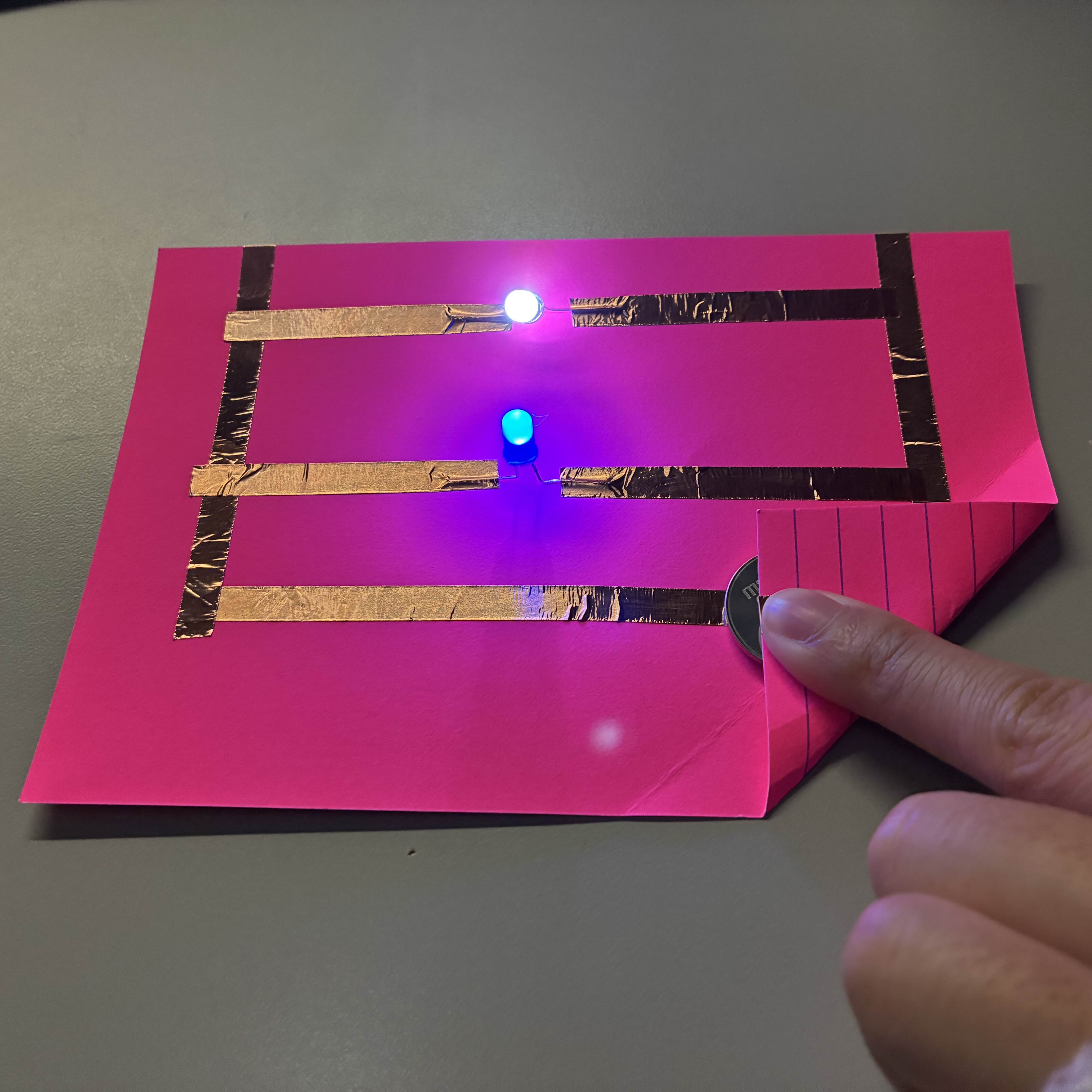 This is my functioning parallel circuit from a lower angle to see how the LED lights are secured by the copper tape and to exemplify the glow of the lights.