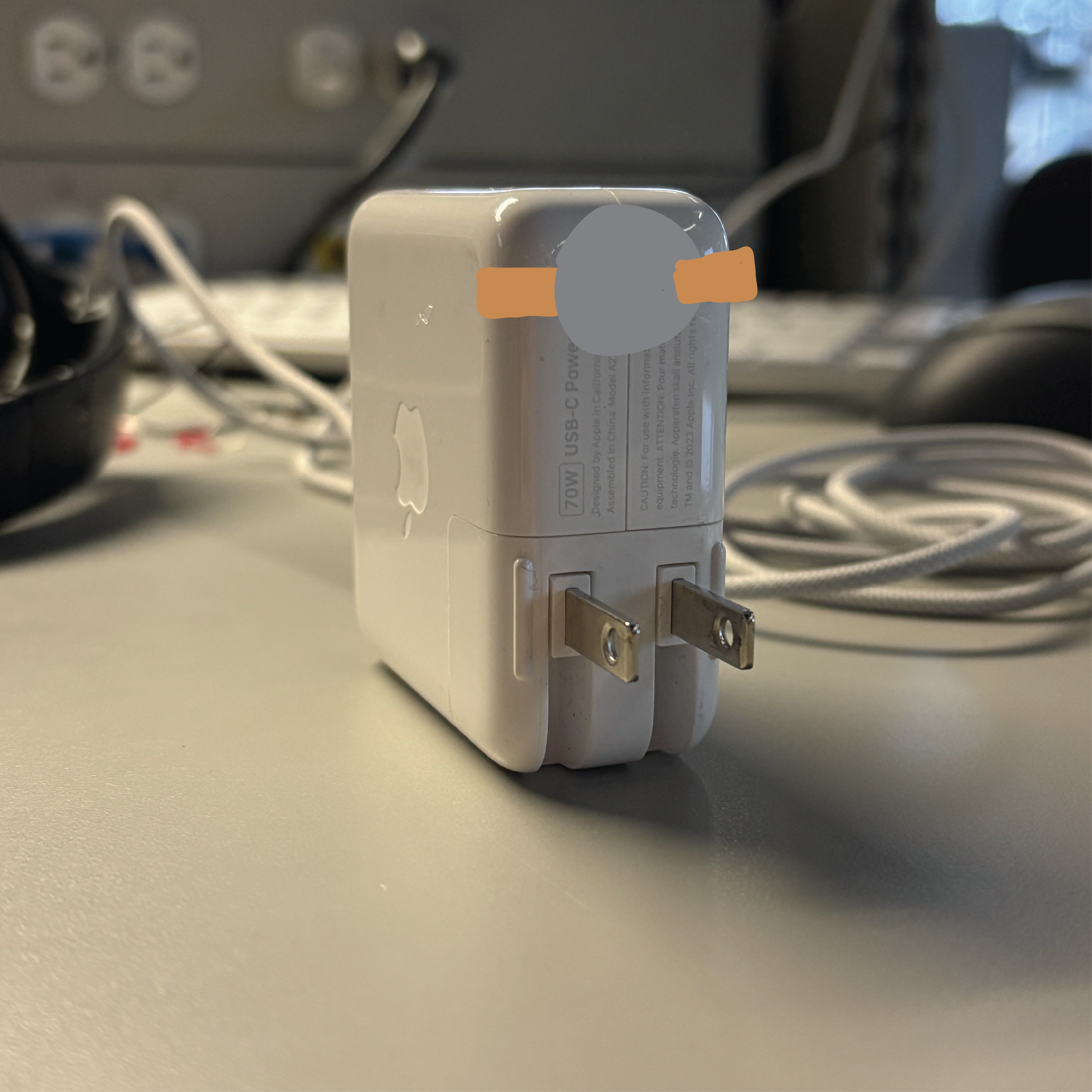 The charger head has copper tape on it with the battery connected to it. The battery lines up with the space between the tape on the outlet.