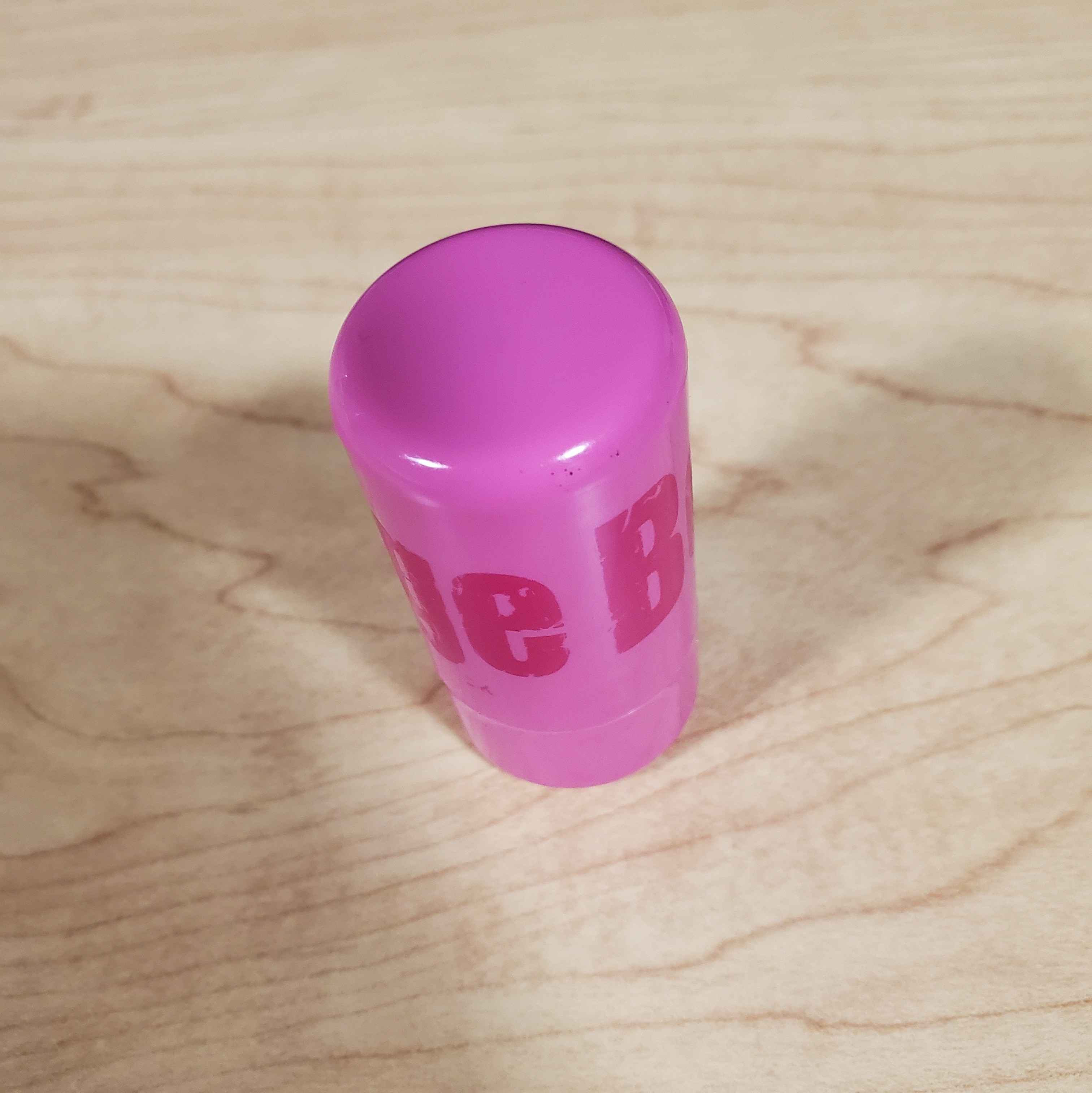 Image of a stick of blush from a upper-facing angle