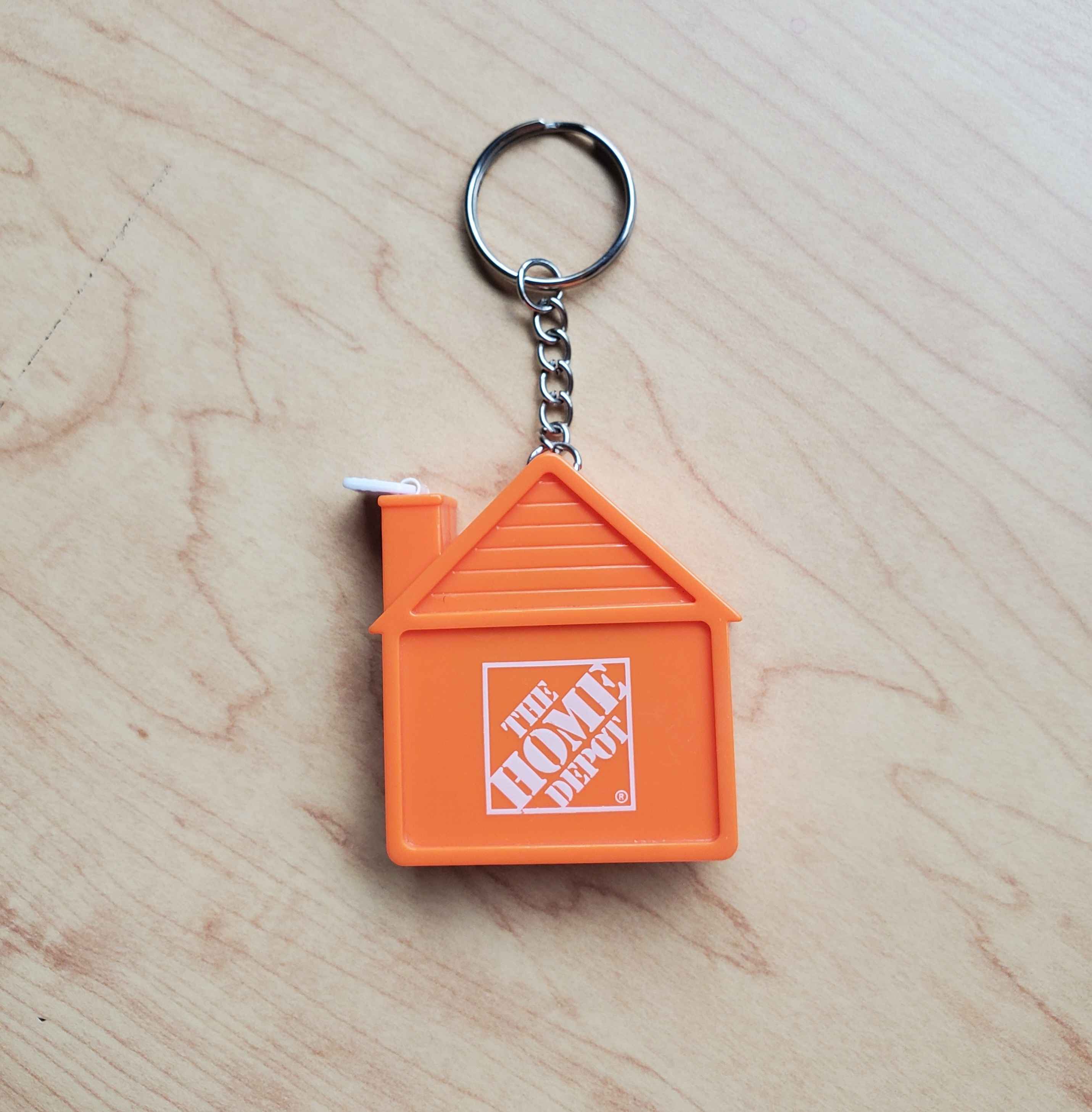 Image of the house-shaped tape measure from the front