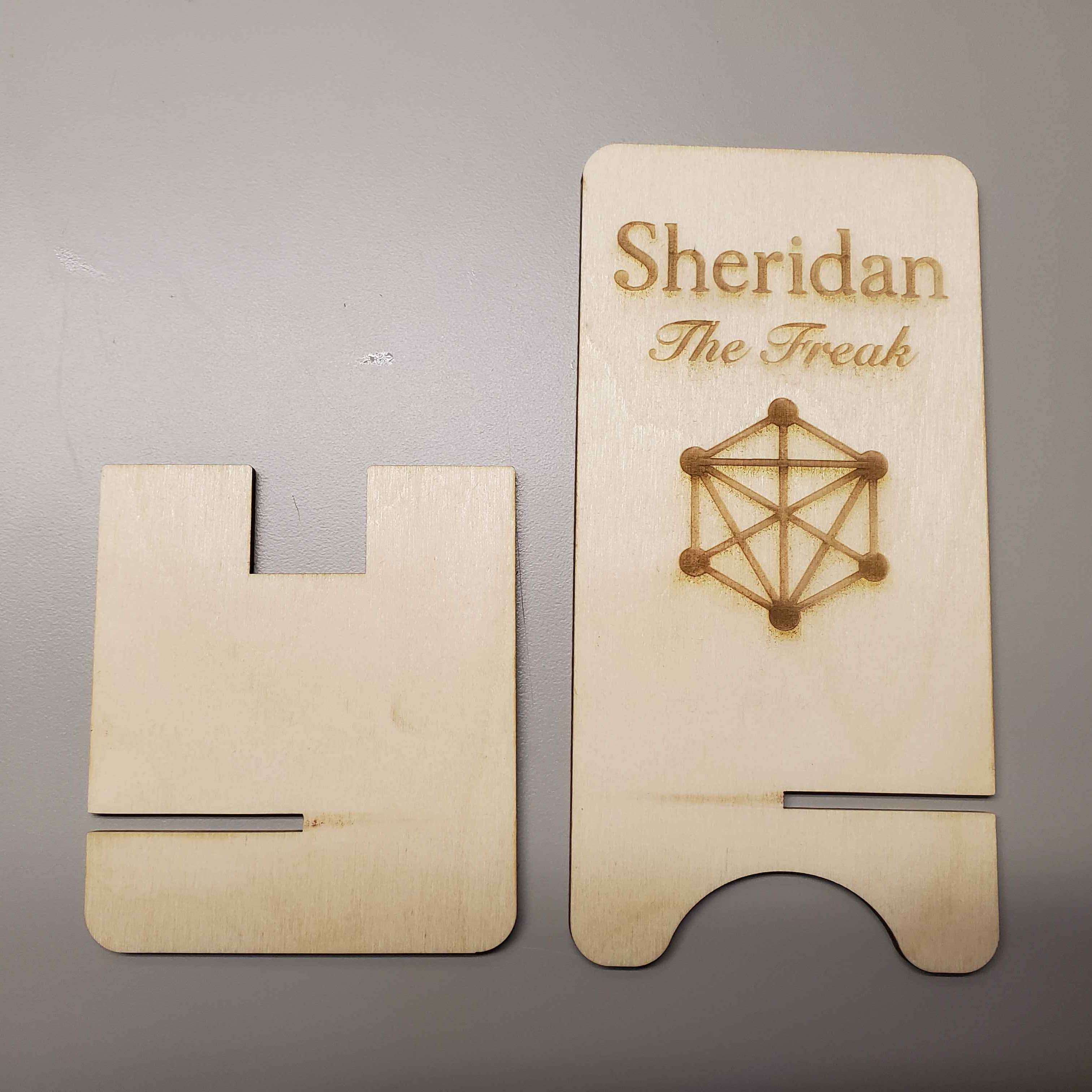 This is the product of the laser-cutting before being sanded, it has produced a phone holder with the IXD logo, the word 'Sheridan', and the words 'The Freak'
