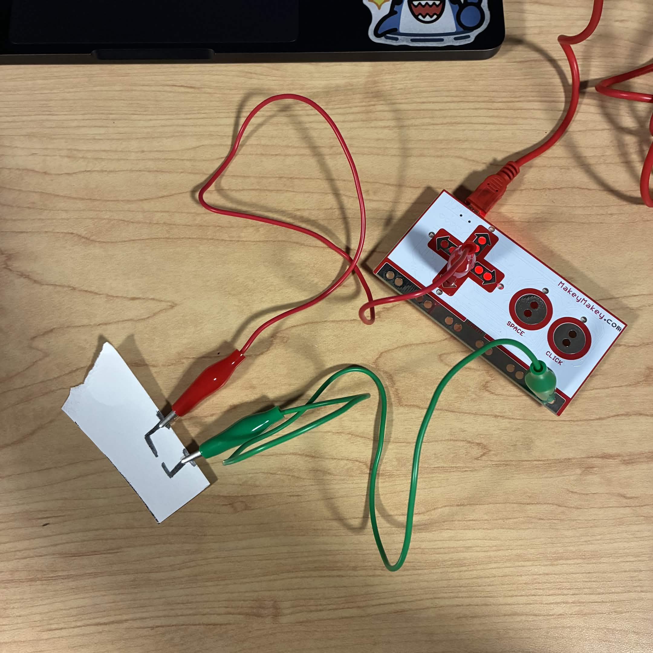 I drew a circuit with a 0.7 led mechnical pencil to see if the graphite would be conductive. The green wire is connected to the ground and the red wire is connected to the down button.  