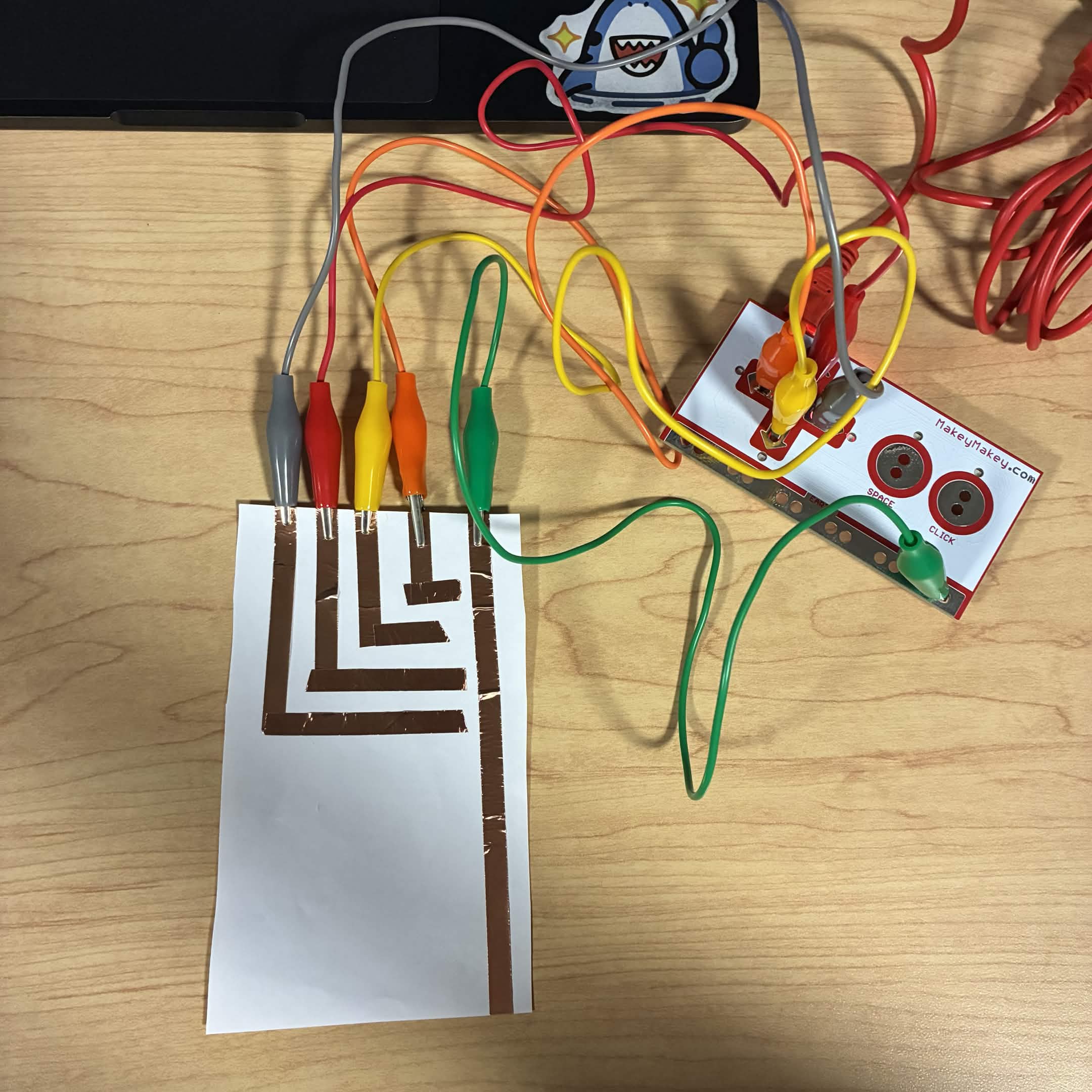 Shows all the wires and circuits and where they connect onto the Makey Makey.